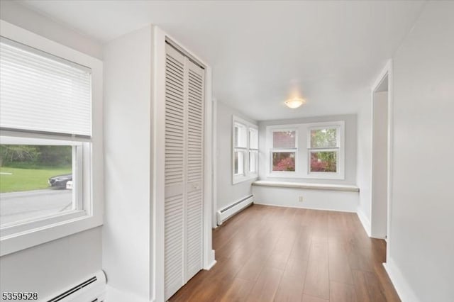 19 Spring St, Ogdensburg Boro, NJ 07439 - hall with a baseboard heating unit, a baseboard radiator, wood finished floors, and baseboards