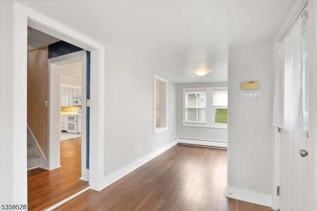 19 Spring St, Ogdensburg Boro, NJ 07439 - spare room with a baseboard heating unit, dark wood-type flooring, and baseboards
