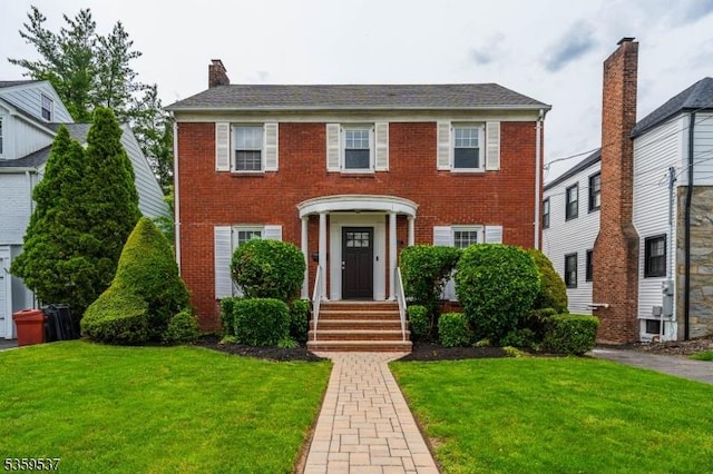 1082 Battle Hill Ter, Union Twp, NJ 07083 - colonial-style house featuring a front lawn, brick siding, and a chimney
