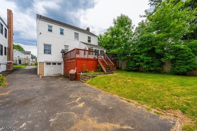 1082 Battle Hill Ter, Union Twp, NJ 07083 - rear view of house with stairs, asphalt driveway, a deck, a garage, and a lawn
