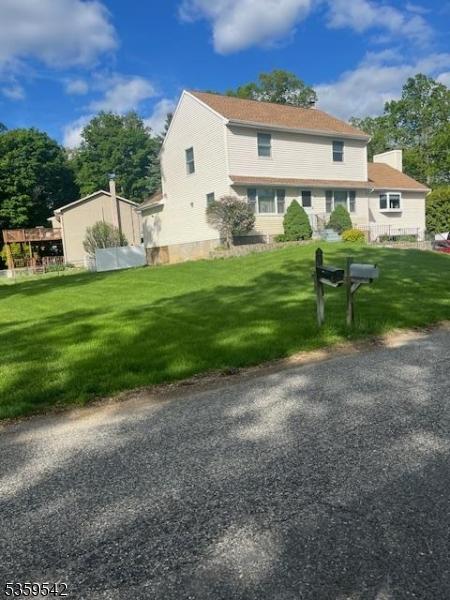 2 Erin Ln, Vernon Twp, NJ 07422 - rear view of house featuring a yard and a chimney