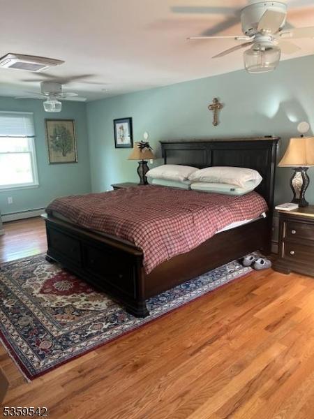 2 Erin Ln, Vernon Twp, NJ 07422 - bedroom featuring wood finished floors, ceiling fan, and baseboard heating
