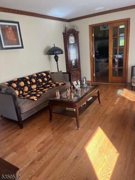 2 Erin Ln, Vernon Twp, NJ 07422 - living area with light wood-style flooring and crown molding