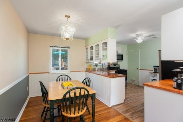 3 Cumberland Rd, Hillsborough Twp, NJ 08844 - dining area with wainscoting, wood finished floors, a chandelier, and ceiling fan