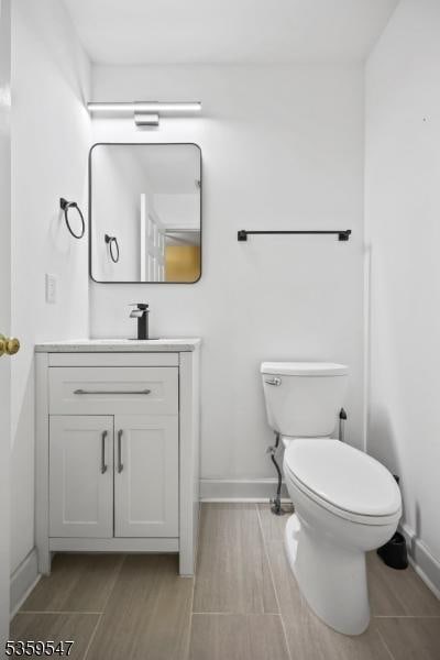 256 Marcia Way, Bridgewater Twp, NJ 08807 - bathroom featuring vanity, baseboards, toilet, and wood tiled floors
