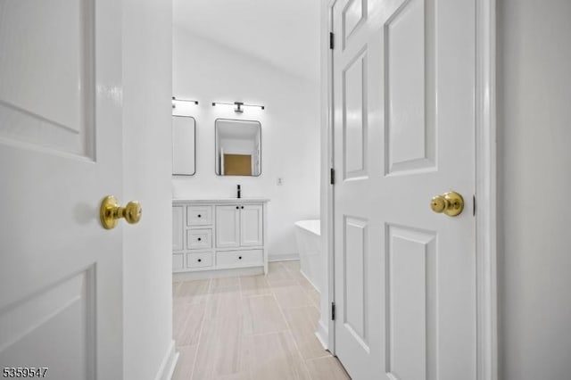256 Marcia Way, Bridgewater Twp, NJ 08807 - bathroom featuring vanity, a soaking tub, baseboards, and lofted ceiling