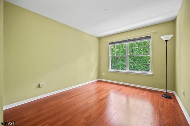 256 Marcia Way, Bridgewater Twp, NJ 08807 - spare room featuring baseboards and wood finished floors