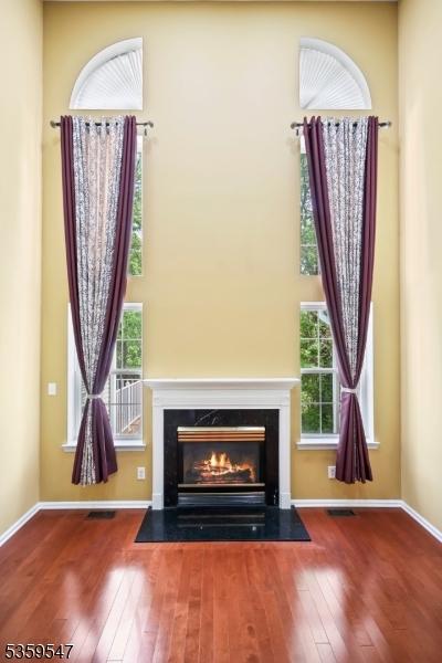 256 Marcia Way, Bridgewater Twp, NJ 08807 - detailed view of wood finished floors, a fireplace with flush hearth, and baseboards
