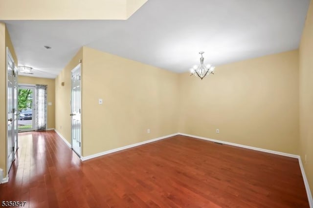 256 Marcia Way, Bridgewater Twp, NJ 08807 - spare room with a chandelier, wood finished floors, and baseboards