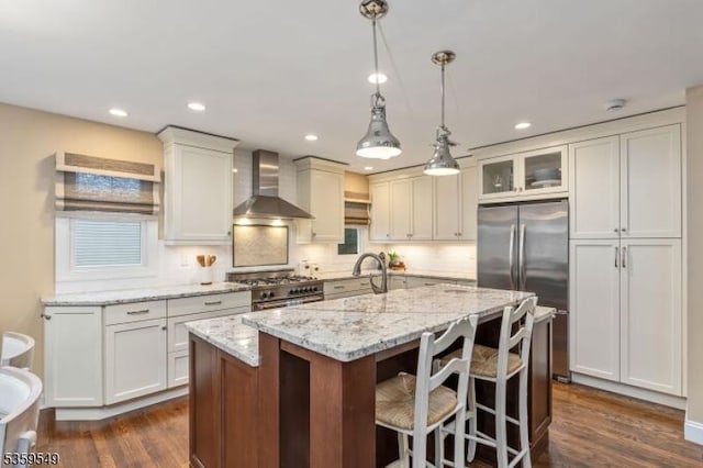 55 Nomahegan Ct, Cranford Twp, NJ 07016 - kitchen featuring wall chimney exhaust hood, stainless steel appliances, dark wood-type flooring, a center island with sink, and light stone countertops