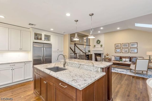 55 Nomahegan Ct, Cranford Twp, NJ 07016 - kitchen with stainless steel fridge, a sink, dark wood-type flooring, white cabinetry, and glass insert cabinets