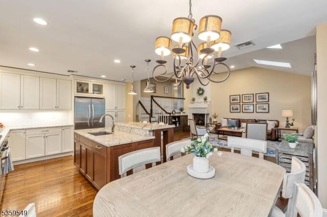 55 Nomahegan Ct, Cranford Twp, NJ 07016 - dining room featuring recessed lighting, wood finished floors, a chandelier, a skylight, and stairway