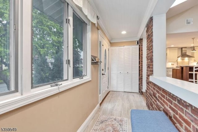 55 Nomahegan Ct, Cranford Twp, NJ 07016 - hallway with light wood-type flooring, brick wall, crown molding, and recessed lighting