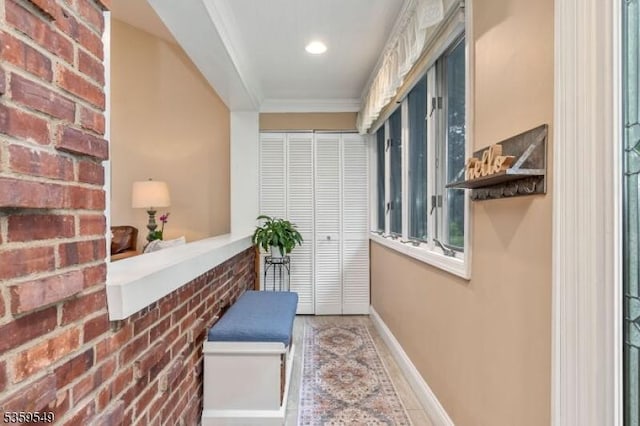 55 Nomahegan Ct, Cranford Twp, NJ 07016 - hall featuring baseboards, ornamental molding, brick wall, and recessed lighting