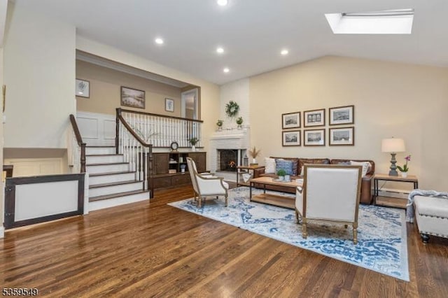 55 Nomahegan Ct, Cranford Twp, NJ 07016 - living room with a warm lit fireplace, wood finished floors, stairway, recessed lighting, and lofted ceiling