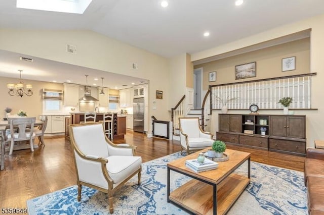 55 Nomahegan Ct, Cranford Twp, NJ 07016 - living area with dark wood finished floors, stairway, lofted ceiling, a chandelier, and a skylight