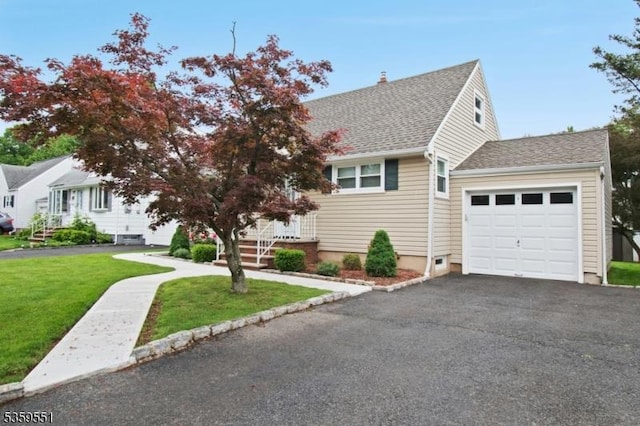 184 Locust Dr, Union Twp, NJ 07083 - view of front facade with an attached garage, a front lawn, driveway, and roof with shingles