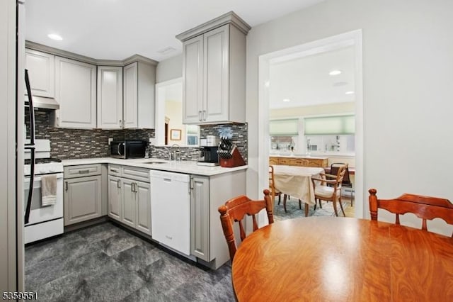 184 Locust Dr, Union Twp, NJ 07083 - kitchen featuring white appliances, gray cabinets, decorative backsplash, under cabinet range hood, and a sink