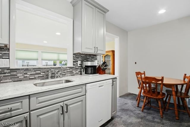 184 Locust Dr, Union Twp, NJ 07083 - kitchen with white dishwasher, a sink, gray cabinetry, decorative backsplash, and light stone countertops
