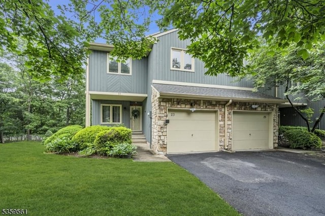 23 Bond St, Bridgewater Twp, NJ 08807 - view of front of house featuring stone siding, driveway, a front yard, and a garage