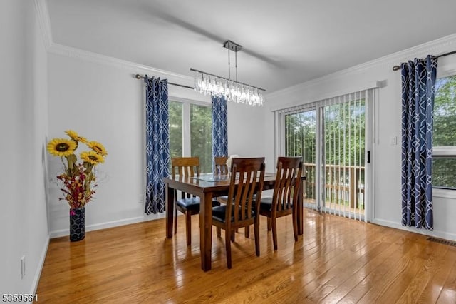 23 Bond St, Bridgewater Twp, NJ 08807 - dining space featuring hardwood / wood-style floors, healthy amount of natural light, crown molding, and a chandelier