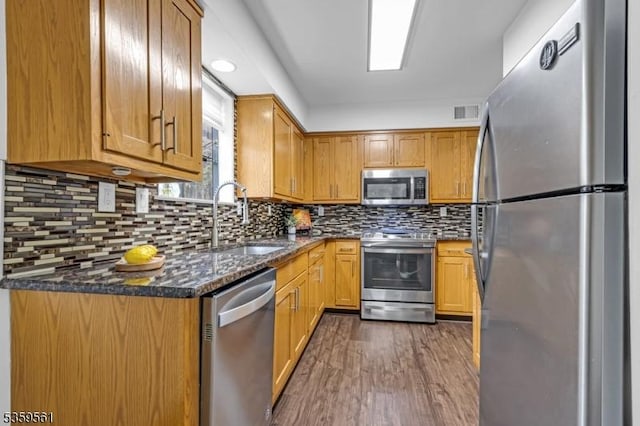 23 Bond St, Bridgewater Twp, NJ 08807 - kitchen featuring stainless steel appliances, dark wood-style floors, tasteful backsplash, and dark stone counters