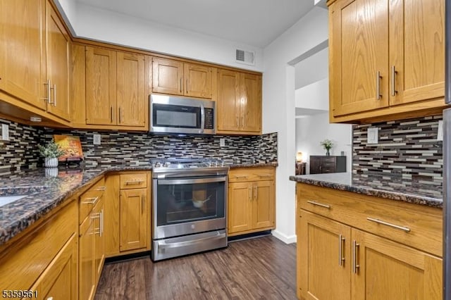 23 Bond St, Bridgewater Twp, NJ 08807 - kitchen featuring stainless steel appliances, decorative backsplash, dark wood-style floors, and dark stone counters