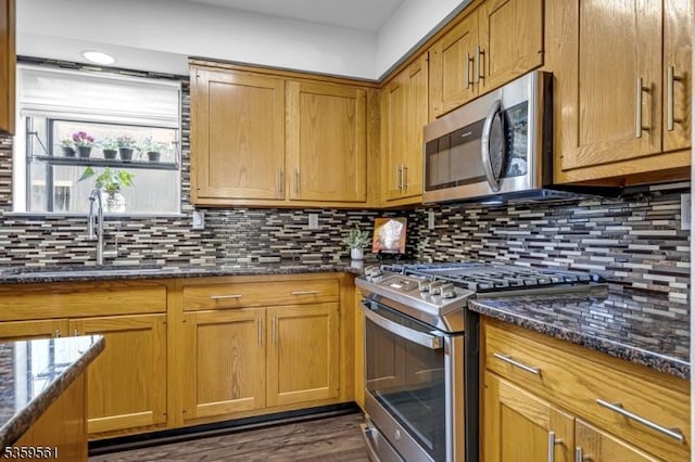 23 Bond St, Bridgewater Twp, NJ 08807 - kitchen with stainless steel appliances, tasteful backsplash, dark stone counters, and brown cabinets