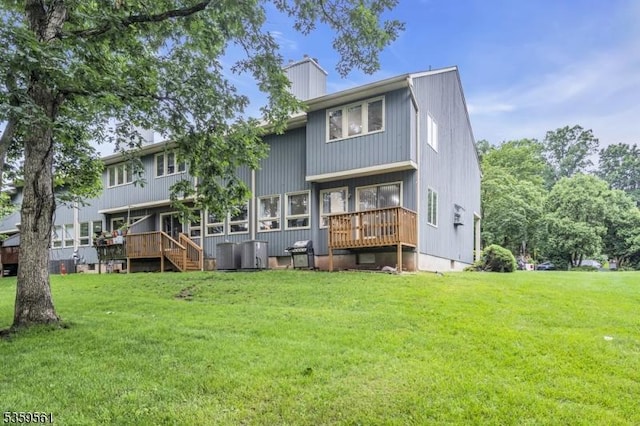 23 Bond St, Bridgewater Twp, NJ 08807 - rear view of property with a lawn, a chimney, and a wooden deck