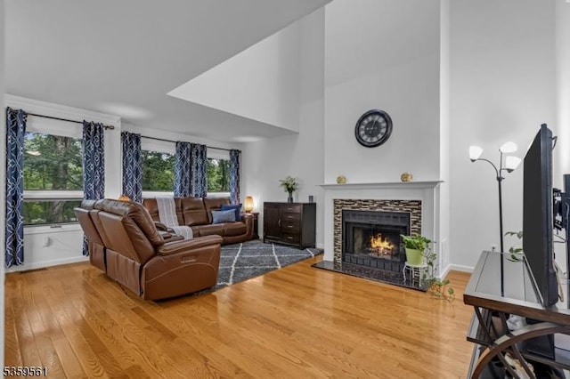 23 Bond St, Bridgewater Twp, NJ 08807 - living area with wood finished floors, a fireplace, and a high ceiling