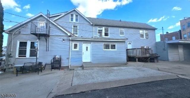 103 Parker St, Newark City, NJ 07104 - rear view of house featuring entry steps, a wooden deck, and a patio area