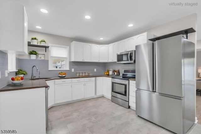 10 Rutgers Way, Hopatcong Boro, NJ 07843 - kitchen with stainless steel appliances, a sink, dark countertops, white cabinets, and open shelves