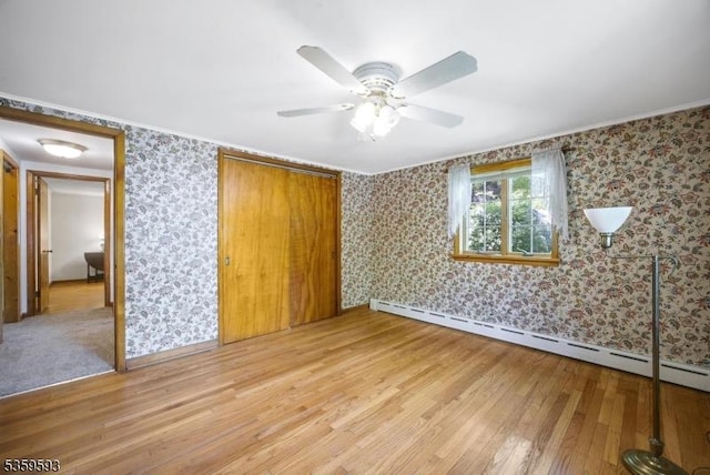 24 Jenkins Rd, Franklin Boro, NJ 07416 - unfurnished bedroom with a baseboard radiator, wallpapered walls, light wood-style floors, a closet, and baseboards