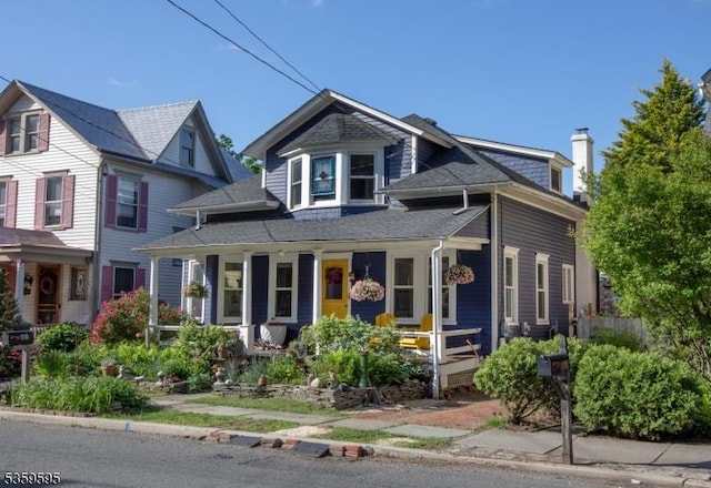 8 S Main St, Stockton Boro, NJ 08559 - view of front facade with covered porch, a chimney, and a shingled roof