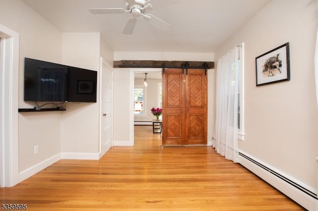 8 S Main St, Stockton Boro, NJ 08559 - unfurnished living room with baseboard heating, light wood-type flooring, baseboards, and a barn door