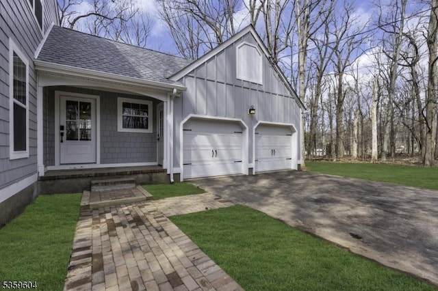 129 Sandy Ridge Rd, Delaware Twp, NJ 08559 - view of front facade with roof with shingles, board and batten siding, concrete driveway, a garage, and a front lawn