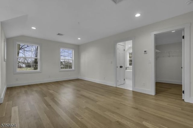 129 Sandy Ridge Rd, Delaware Twp, NJ 08559 - unfurnished bedroom with a spacious closet, baseboards, wood finished floors, ensuite bathroom, and lofted ceiling