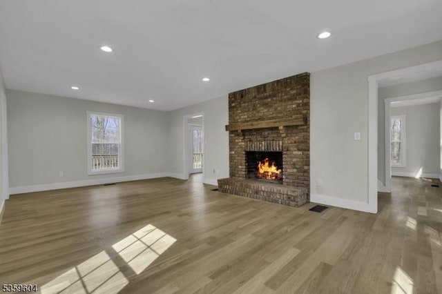 129 Sandy Ridge Rd, Delaware Twp, NJ 08559 - unfurnished living room with a brick fireplace, baseboards, wood finished floors, and recessed lighting