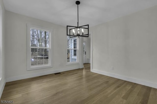 129 Sandy Ridge Rd, Delaware Twp, NJ 08559 - unfurnished dining area featuring wood finished floors, baseboards, and a chandelier