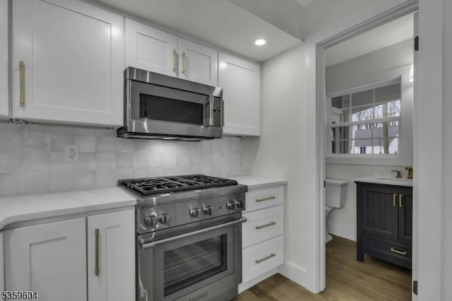 129 Sandy Ridge Rd, Delaware Twp, NJ 08559 - kitchen featuring stainless steel appliances, white cabinets, backsplash, light countertops, and recessed lighting