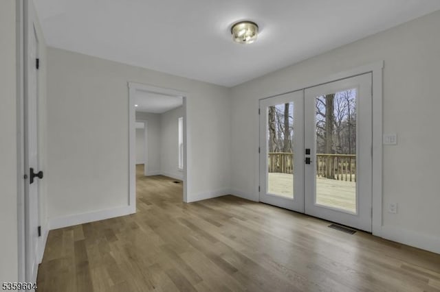 129 Sandy Ridge Rd, Delaware Twp, NJ 08559 - empty room featuring french doors, wood finished floors, and baseboards