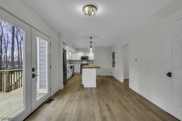 129 Sandy Ridge Rd, Delaware Twp, NJ 08559 - kitchen with high quality fridge, stainless steel microwave, wood counters, white cabinets, and a kitchen island