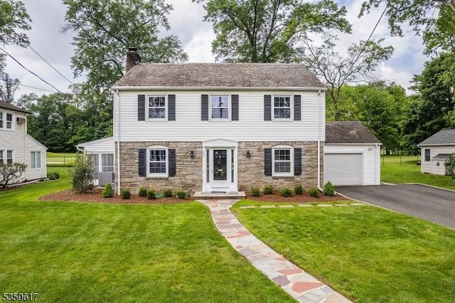 358 Princeton Rd, Union Twp, NJ 07083 - colonial-style house with stone siding, a chimney, asphalt driveway, and a front yard