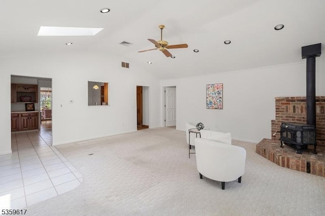 358 Princeton Rd, Union Twp, NJ 07083 - living area featuring a wood stove, light colored carpet, a ceiling fan, vaulted ceiling, and a skylight