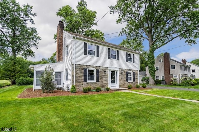 358 Princeton Rd, Union Twp, NJ 07083 - colonial house with a chimney, stone siding, a front lawn, and central AC unit