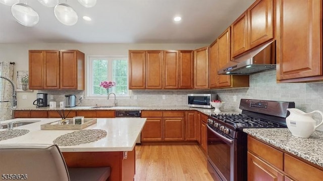 612 Magnolia Rd, North Brunswick Twp, NJ 08902 - kitchen with appliances with stainless steel finishes, under cabinet range hood, a sink, light wood-style floors, and recessed lighting
