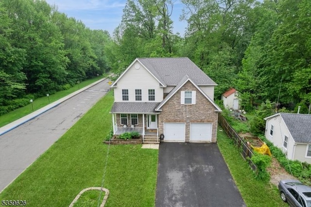 612 Magnolia Rd, North Brunswick Twp, NJ 08902 - traditional home featuring a porch, stone siding, driveway, a front lawn, and a garage