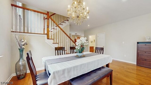612 Magnolia Rd, North Brunswick Twp, NJ 08902 - dining room with stairway, wood finished floors, a chandelier, baseboards, and recessed lighting