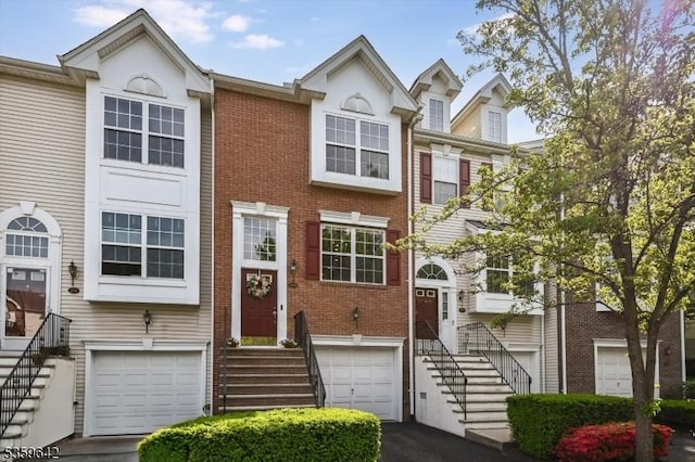 213 Cheshire Ct, Nutley Twp, NJ 07110 - townhome / multi-family property with an attached garage, brick siding, asphalt driveway, and entry steps