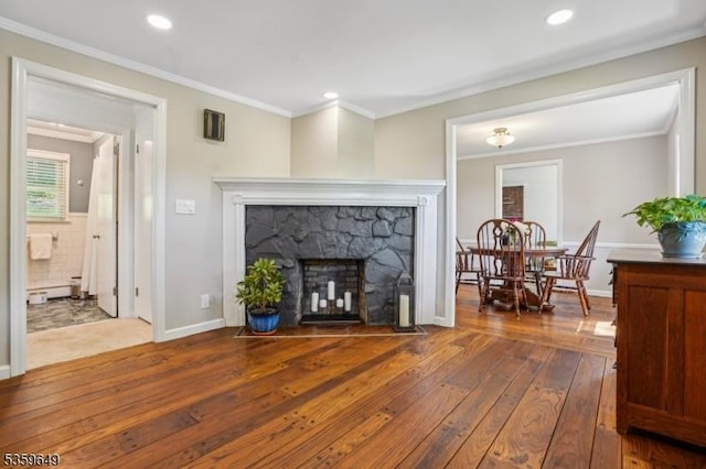 1794 Long Hill Rd, Long Hill Twp, NJ 07946 - living area with hardwood / wood-style floors, ornamental molding, a stone fireplace, recessed lighting, and a baseboard radiator